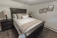 Private bedroom with dark wood bed frame